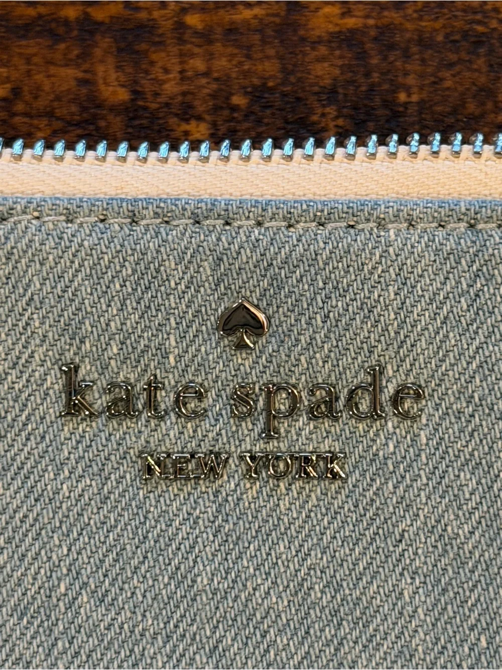 kate spade light denim wristlet with cream strap